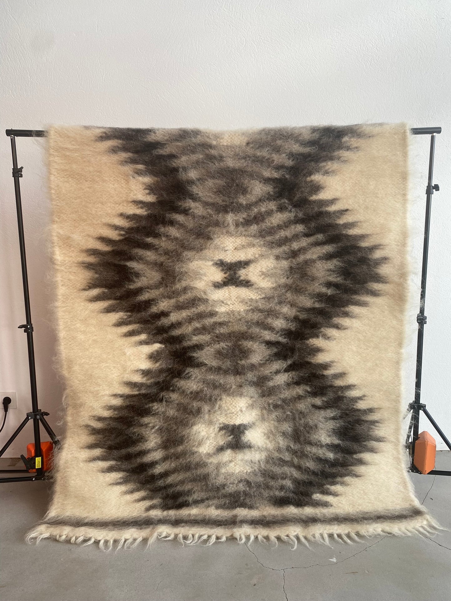 Wool throw blanket in warm gray tone. Handmade, breathable, and hypoallergenic – an elegant and lasting addition to your home.
